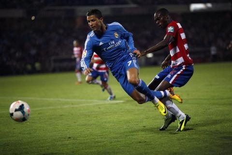 Real Madrid's Cristiano Ronaldo (L) battles for the ball with Granada's Allan Nyom