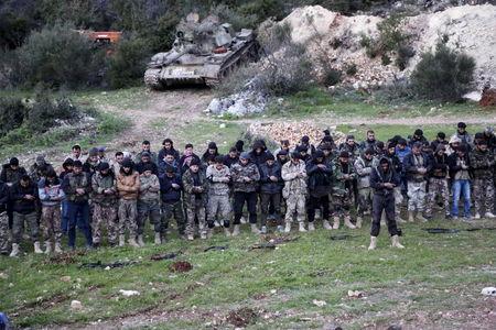 Rebel fighters pray before heading towards what they said was an offensive to take control of the northwestern town of Jisr al-Shughour and the surrounding areas, which are controlled by forces loyal to Syria's President Bashar al-Assad, April 20, 2015. PHOTO BY REUTERS/Khalil Ashawi