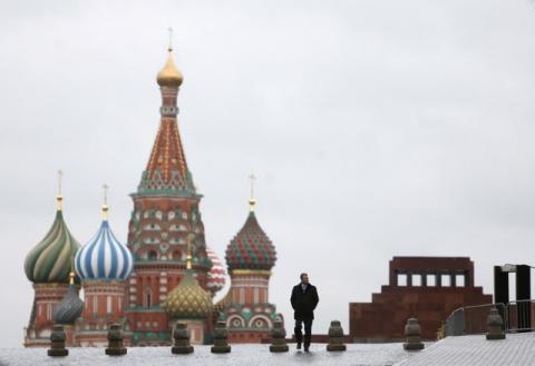 A man walks along Red Square, with the mausoleum of Soviet state founder Vladimir Lenin (R) and St. Basil's Cathedral seen in the background, in central Moscow, Russia, December 21, 2015. PHOTO BY REUTERS/Maxim Shemetov