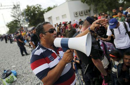 Nizar Shoukry speaks through a megaphone at railway station in Tovarnik, Croatia, September 19, 2015. Love brought Nizar Shoukry from his native Syria to Croatia and eventually a dental practice in the border town of Tovarnik. Thirty years later, war is bringing his countrymen, in a chaotic, desperate tide flowing past Shoukry's door en route to Germany and a promise of asylum. REUTERS/Antonio Bronic