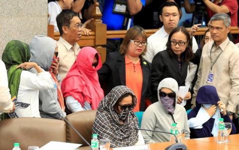 Relatives of slain people cover their faces as they attend a Senate hearing investigating drug-related killings at the Senate headquarters in Pasay city, metro Manila, Philippines, August 22, 2016. PHOTO BY REUTERS/Romeo Ranoco