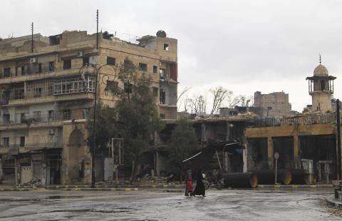 Civilians walk along a deserted street in the old city of Aleppo, January 6, 2015. PHOTO BY REUTERS/Jalal Al-Mamo