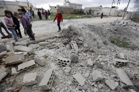 Residents inspect damaged ground after a shell fell in the rebel held town of Jarjanaz, southern Idlib countryside, Syria March 5, 2016. PHOTO BY REUTERS/Khalil Ashawi