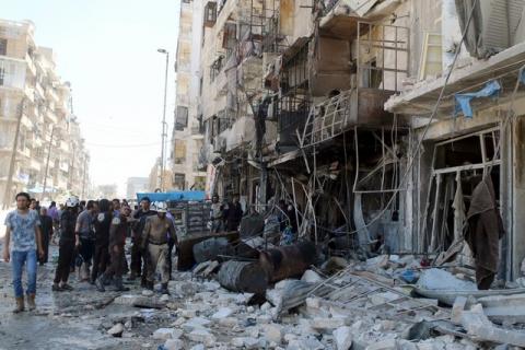 Residents and civil defence members inspect a damaged building after an airstrike on the rebel-held Tariq al-Bab neighbourhood of Aleppo, Syria, April 23, 2016. PHOTO BY REUTERS/Abdalrhman Ismail