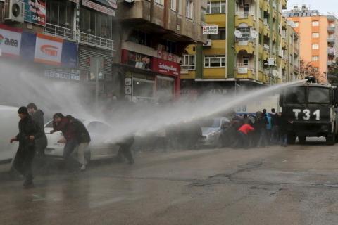 Turkish riot police use a water cannon to disperse Kurdish demonstrators during a protest against a curfew in Sur district and security operations in the region, in the southeastern city of Diyarbakir, Turkey, January 17, 2016. PHOTO BY REUTERS/Sertac Kayar