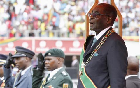 Zimbabwe's President Robert Mugabe stands during celebrations to mark his country's 34th Independence Day in Harare