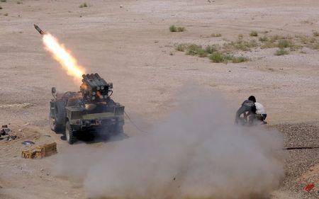 Members of Iraq's Shi'ite paramilitaries launch a rocket towards Islamic State militants in the outskirts of the city of Falluja, in the province of Anbar, Iraq, July 12, 2015. PHOTO BY REUTERS/Stringer