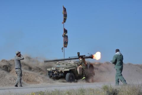 Shi'ite fighters fire a rocket toward Islamic State militants on the outskirts of Fallujah, west of Baghdad. PHOTO BY REUTERS/Stringer