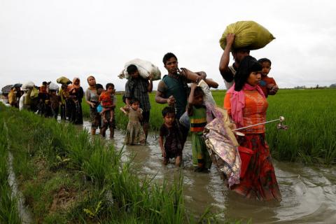 A group of Rohingya refugee people walk in the water after crossing the Bangladesh-Myanmar border in Teknaf, Bangladesh, September 1, 2017. PHOTO BY REUTERS/Mohammad Ponir Hossain