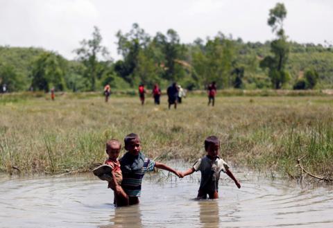 Rohingya children make their way through water as they try to come to the Bangladesh side from No Man’s Land after a gunshot being heard on the Myanmar side, in Cox’s Bazar, Bangladesh. PHOTO BY REUTERS/Mohammad Ponir Hossain