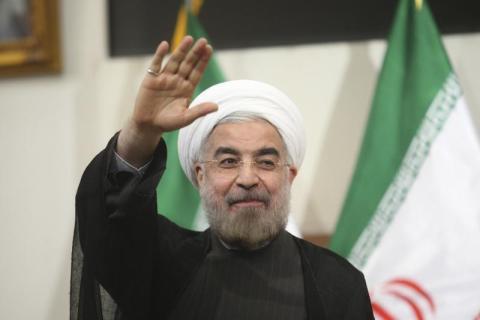 Iranian President-elect Hassan Rouhani gestures to the media during a news conference in Tehran