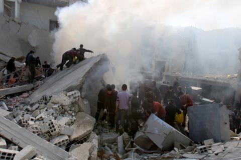 Residents remove debris while looking for survivors amid the rubble of collapsed buildings after what activists said were air strikes by forces loyal to Syria's President Bashar al-Assad in Arbeen, in the eastern Damascus suburb of Ghouta, February 21, 2015. PHOTO BY REUTERS/Yaseen Al-Bushy