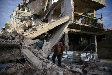 A person inspects damaged building in the besieged town of Douma, Eastern Ghouta, Damascus, Syria, February 20, 2018. PHOTO BY REUTERS/Bassam Khabieh