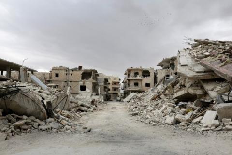 Birds fly over a damaged neighbourhood, in the rebel-controlled area of Maaret al-Numan town in Idlib province, Syria, May 23, 2016. PHOTO BY REUTERS/Khalil Ashawi