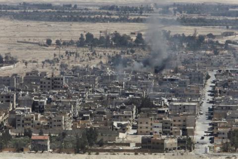 Smoke rises from the modern city of Palmyra, in Homs Governorate, Syria April 1, 2016. PHOTO BY REUTERS/Omar Sanadiki