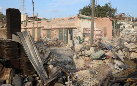 A Somali shop owner stands next to the ruins of his shop at the scene of last Saturday explosion in KM4 street in the Hodan district in Mogadishu, Somalia, October 17, 2017. PHOTO BY REUTERS/Feisal Omar