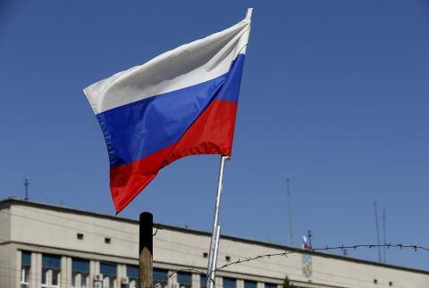 The Russian national flag is seen on a barricade near the seized office of the SBU state security service in Luhansk, eastern Ukraine