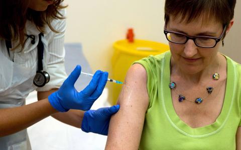 Volunteer Ruth Atkins receives an injection of the Ebola vaccine, at the Oxford Vaccine Group Centre for Clinical Vaccinology and Tropical Medicine (CCVTM) in Oxford, southern England 
