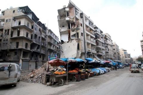 Stalls are on a street beside damaged buildings in the rebel held al-Shaar neighborhood of Aleppo, Syria, February 10, 2016. PHOTO BY REUTERS/Abdalrhman Ismail
