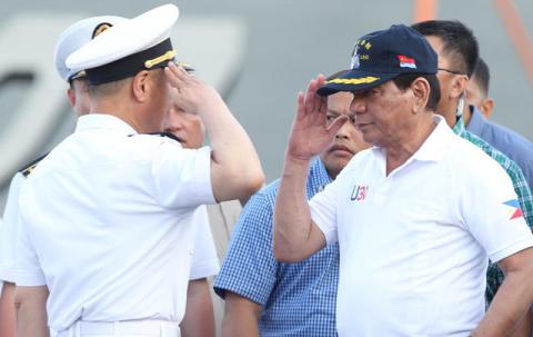 Philippine President Rodrigo Duterte returns the salute of a Chinese Navy officer as he tours a Chinese Naval ship during a visit to Davao city, southern Philippines, May 1, 2017. PHOTO BY REUTERS/Lean Daval Jr