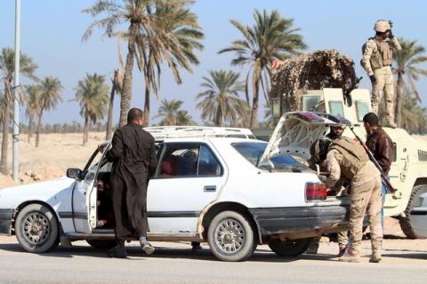 Iraqi soldiers search vehicles on the outskirts of Basra, January 14, 2016. PHOTO BY REUTERS/Essam Al-Sudani