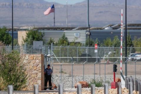 A security officer keeps watch over a tent encampment housing immigrant children just north of the Mexican border in Tornillo, Texas, U.S., June 20, 2018. PHOTO BY REUTERS/Mike Blake