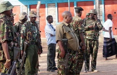 Kenya Defence Forces soldiers and policemen gather at the scene of an overnight attack on a residential complex in Soko Mbuzi village of Mandera town at the Kenya-Somalia border, July 7, 2015. PHOTO BY REUTERS/Stringer