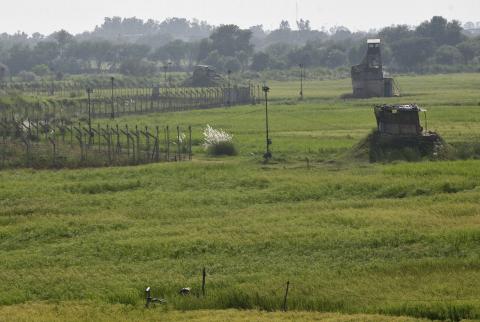 Indian security posts (R) are seen along the border between India and Pakistan in Suchetgarh near Jammu
