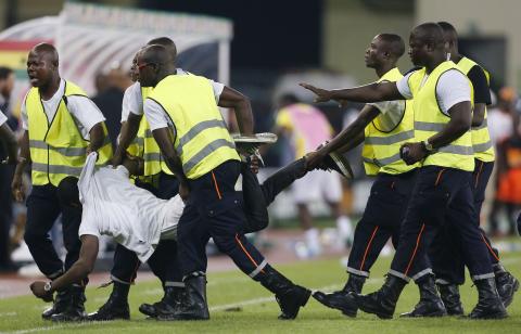 Security detain an Equatorial Guinea fan on the pitch after he tried to attack the referee during the 2015 African Cup of Nations semi-final soccer match against Ghana in Malabo, February 5, 2015. PHOTO BY REUTERS/Amr Abdallah Dalsh