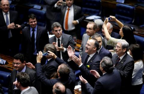 Members of Brazil's Senate react after a vote to impeach President Dilma Rousseff for breaking budget laws in Brasilia, Brazil, May 12, 2016. PHOTO BY REUTERS/Ueslei Marcelino