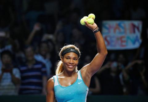 Serena Williams of the U.S. celebrates her win over Caroline Wozniacki of Denmark during their WTA Finals singles semi-finals tennis match at the Singapore Indoor Stadium, October 25, 2014. PHOTO BY REUTERS/Edgar Su