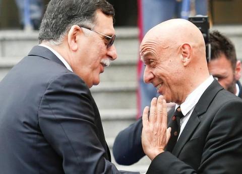 Faiez Mustafa Serraj, President of the Presidency Council of the Government of National Accord of Libya (L), is greeted by Italian Interior Minister Marco Minniti during a meeting in Rome, Italy, March 20, 2017. PHOTO BY REUTERS/Remo Casilli
