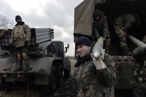 Ukrainian servicemen unload Grad rockets from a truck before launching them towards pro-Russian separatist forces outside Debaltseve, eastern Ukraine, February 8, 2015. PHOTO BY REUTERS/Alexei Chernyshev