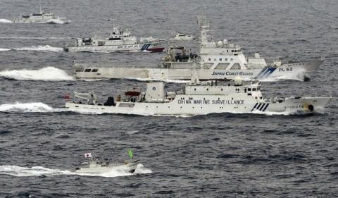 A Chinese marine surveillance ship Haijian No. 66 (C) cruising next to Japan Coast Guard patrol ships in the East China Sea, near what are known as the Senkaku isles in Japan and the Diaoyu islands in China, April 23, 2013. PHOTO BY REUTERS/Kyodo
