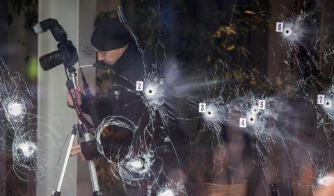 Investigative personnel work at the scene of a cafe shooting in Oesterbro, in Copenhagen, February 15, 2015. PHOTO BY REUTERS/Hannibal Hanschke
