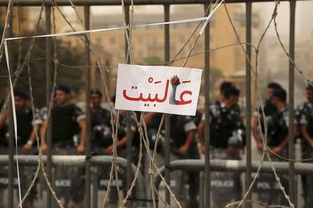 A sign reading, "Go home" is placed on a barbed wire as policemen block a street leading to the parliament building where a session of "national dialogue" is taking place in downtown Beirut, Lebanon, September 9, 2015. PHOTO BY REUTERS/Aziz Taher