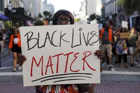 Louise Brown walks in the "March for Black Lives" after passing by the Emanuel African Methodist Episcopal Church in Charleston, South Carolina June 20, 2015 three days after a mass shooting left nine dead during a bible study at the church. PHOTO BY REUTERS/Brian Snyder