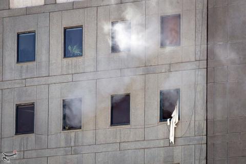 Smoke is seen during an attack on the Iranian parliament in central Tehran, Iran. PHOTO BY REUTERS/Tasnim News Agency