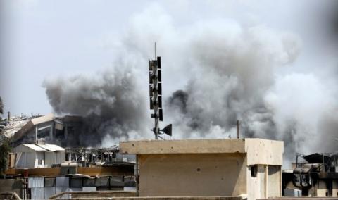 Smoke billows from the Islamic State militants positions after an artillery attack by the Iraqi soldiers in western Mosul, Iraq, June 18, 2017. PHOTO BY REUTERS/Erik De Castro
