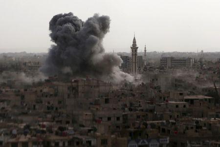 Smoke rises from what activists said was an airstrike by forces loyal to Syria's President Bashar al-Assad on the town of Douma, eastern Ghouta of Damascus, September 16, 2015. PHOTO BY REUTERS/Bassam Khabieh