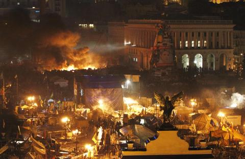 Smoke rises above burning barricades at Independence Square during anti-government protests in Kiev