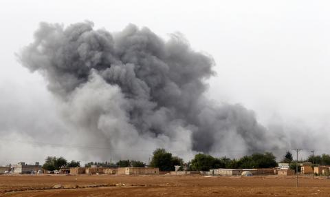 Smoke rises from the Syrian town of Kobani, seen from near the Mursitpinar border crossing on the Turkish-Syrian border in the southeastern town of Suruc in Sanliurfa province