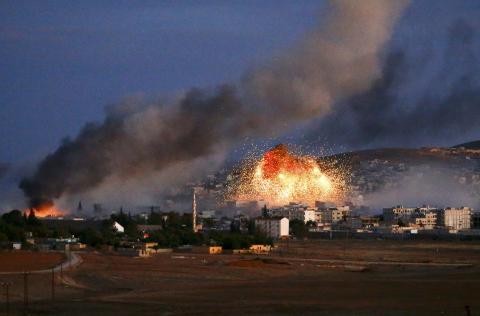 Smoke and flames rise over Syrian town of Kobani after an airstrike, as seen from the Mursitpinar crossing on the Turkish-Syrian border in the southeastern town of Suruc in Sanliurfa province, October 20, 2014. PHOTO BY REUTERS/Kai Pfaffenbach
