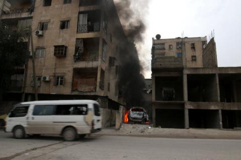 Smoke rises from a car after strikes on the rebel-held besieged al-Zebdieh district, in Aleppo Syria, December 5, 2016. PHOTO BY REUTERS/Abdalrhman Ismail