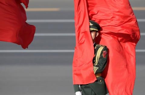 A soldier from honour guards holds a red flag during a welcoming ceremony held for Vietnam's President Tran Dai Quang outside the Great Hall of the People, in Beijing, China, May 11, 2017. PHOTO BY REUTERS/Jason Lee