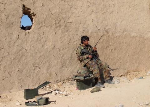 An Afghan National Army (ANA) soldier speaks on a radio at an outpost in Helmand province, December 20, 2015. PHOTO BY REUTERS/Abdul Malik