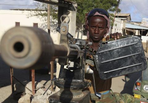 A Somali army soldier takes his position behind a machine gun after entering the town of Barawe during the second phase of Operation Indian Ocean