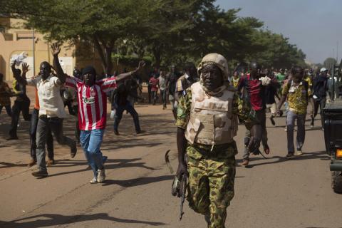 A soldier runs from anti-government protesters as they take over the parliament building in Ouagadougou, capital of Burkina Faso, October 30, 2014. PHOTO BY REUTERS/Joe Penney