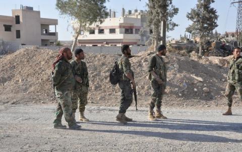 Forces loyal to Syria's President Bashar al-Assad walk in the town of al-Qaryatain, Syria, after they recaptured it in this picture provided by SANA on April 3, 2016. PHOTO BY REUTERS/SANA