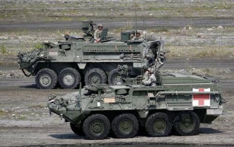 U.S. soldiers aboard armoured vehicles take part during a military exercise with Philippine troops called "Balikatan" (shoulder-to-shoulder) in Capas, Tarlac in northern Philippines, April 14, 2016. PHOTO BY REUTERS/Erik De Castro